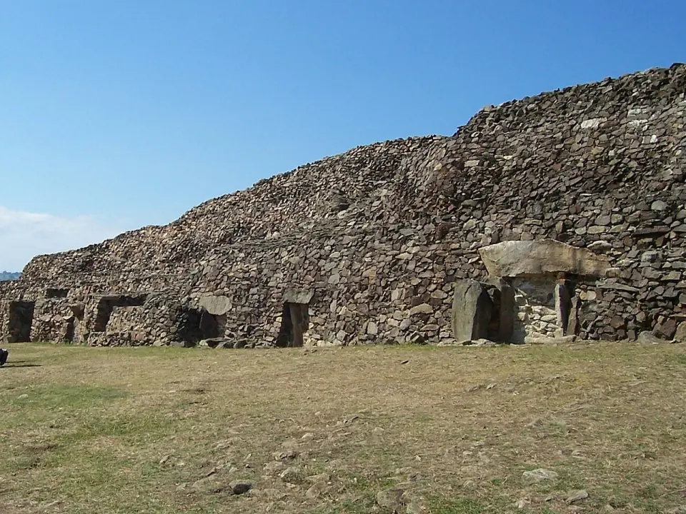 Façade du cairn de Barnenez avec les entrées de dolmens, sous un ciel bleu